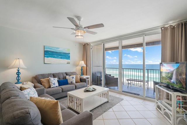 tiled living room featuring expansive windows and ceiling fan