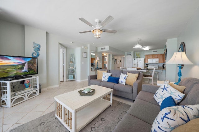 living room with ceiling fan and light tile patterned flooring