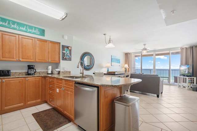 kitchen featuring floor to ceiling windows, sink, hanging light fixtures, stainless steel dishwasher, and kitchen peninsula