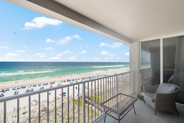 balcony with a water view and a beach view