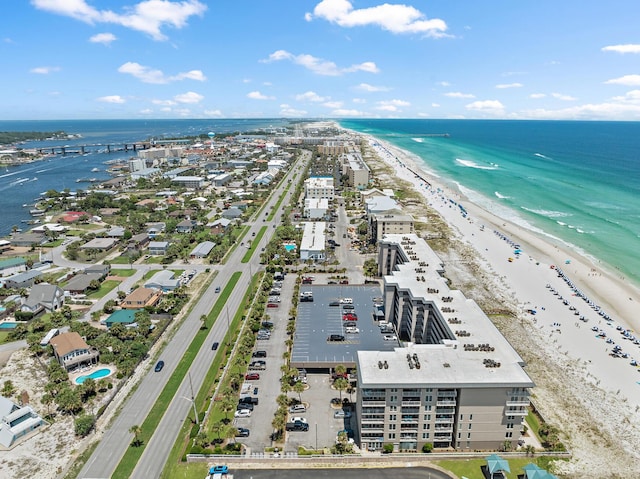 drone / aerial view featuring a water view and a beach view