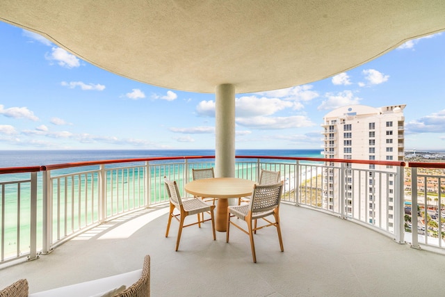 balcony featuring a water view and a beach view