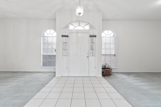 carpeted foyer entrance featuring plenty of natural light