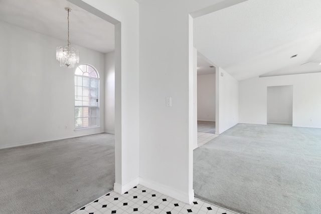 carpeted spare room with lofted ceiling and a chandelier