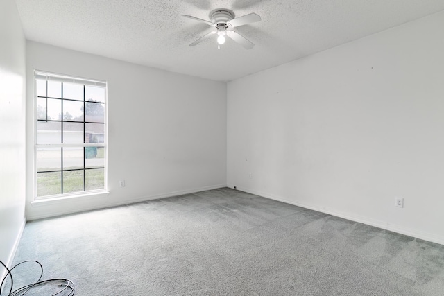 empty room with ceiling fan, a healthy amount of sunlight, and light carpet