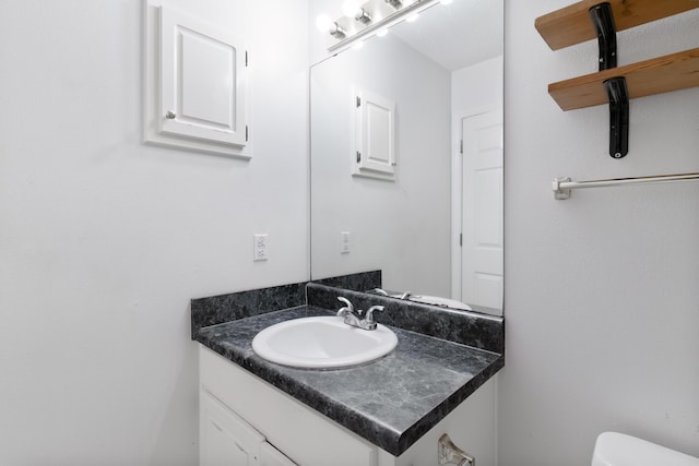 bathroom featuring vanity and toilet