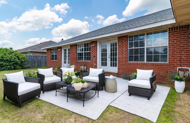 view of patio featuring a wooden deck, fence, an outdoor living space, and french doors