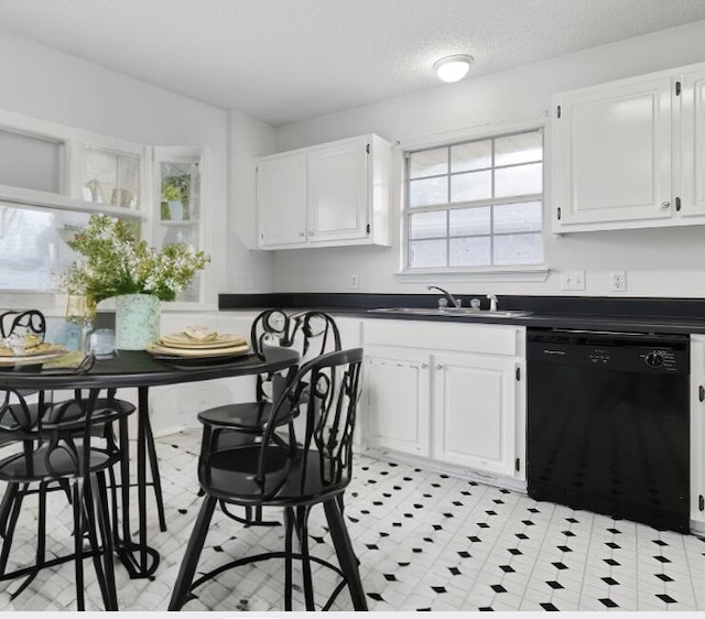 kitchen featuring dishwasher, sink, a textured ceiling, and white cabinets