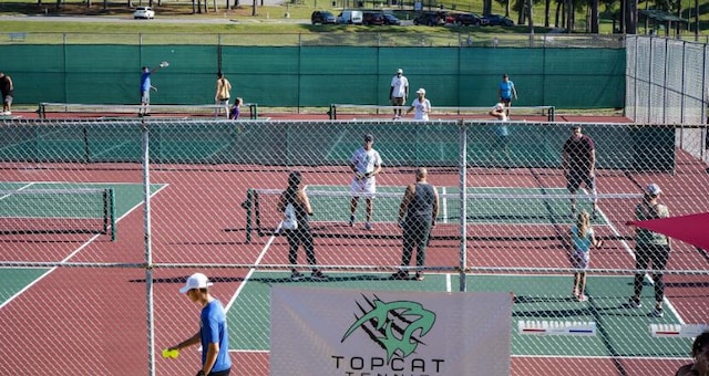 view of tennis court featuring fence