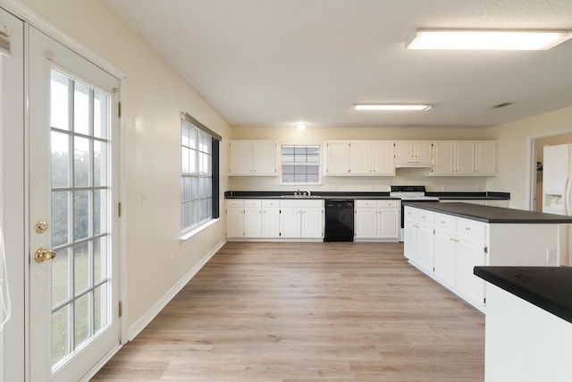 kitchen featuring dishwasher, range with electric cooktop, dark countertops, and white cabinetry