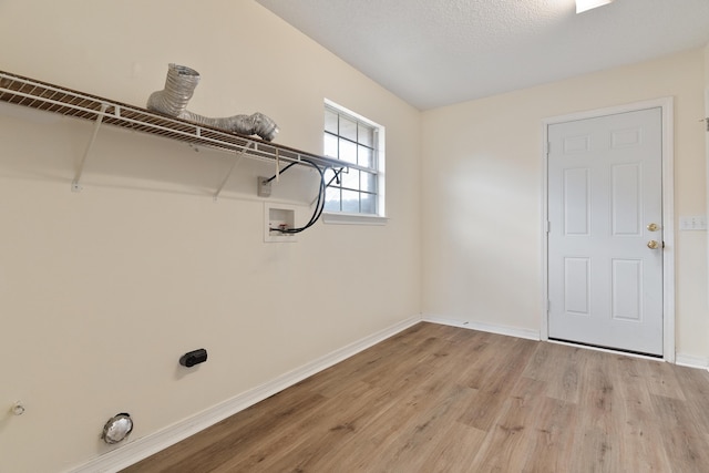 laundry area featuring laundry area, hookup for a washing machine, baseboards, and light wood finished floors