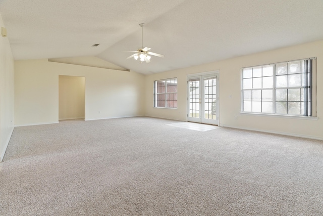 spare room with vaulted ceiling, french doors, carpet, and a ceiling fan