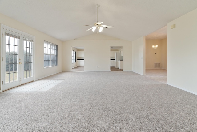 unfurnished living room featuring ceiling fan with notable chandelier, carpet floors, visible vents, baseboards, and french doors