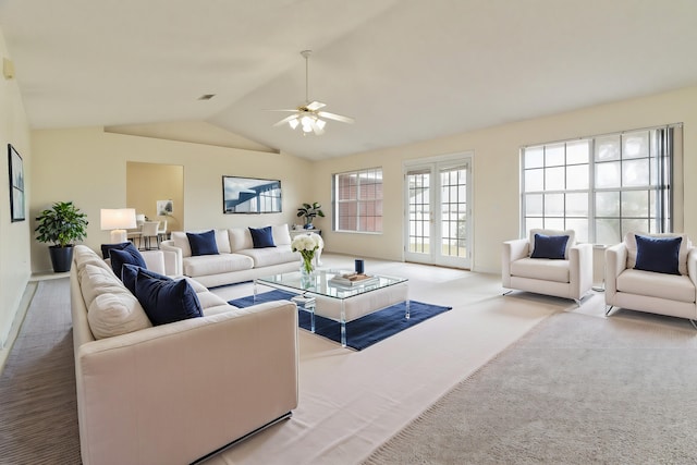 carpeted living area with a ceiling fan, lofted ceiling, french doors, and visible vents