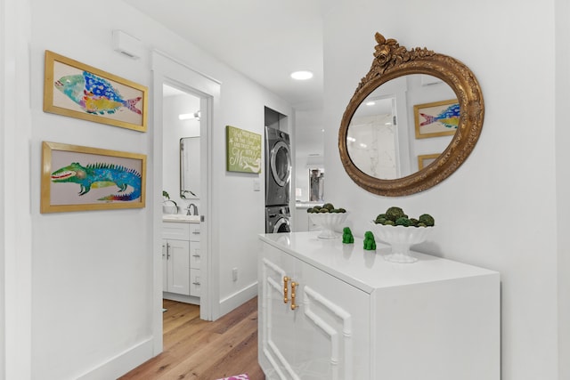 bathroom featuring stacked washer and dryer, wood-type flooring, and vanity