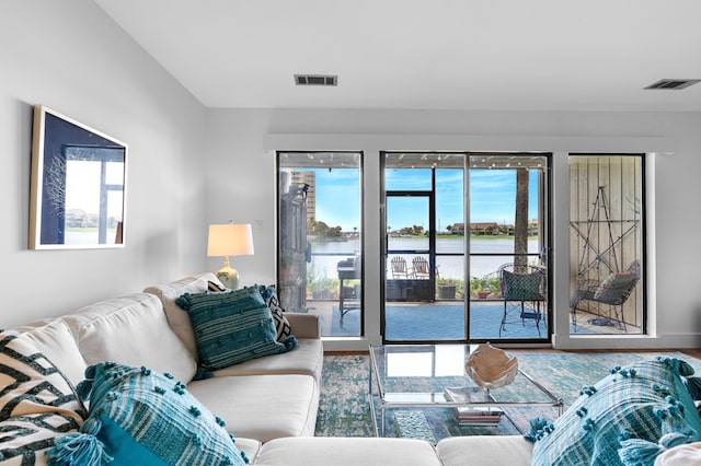 living room featuring hardwood / wood-style floors and a water view