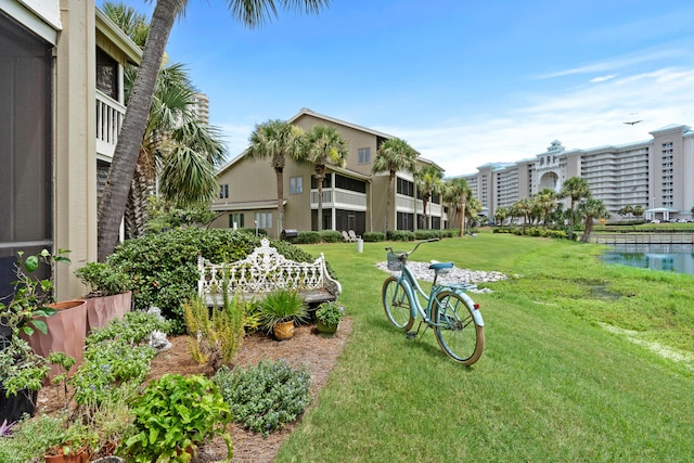 view of property's community featuring a water view and a lawn