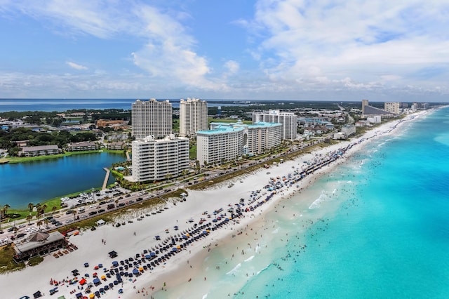 birds eye view of property featuring a beach view and a water view