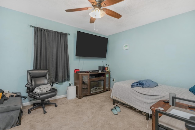 carpeted bedroom with ceiling fan and a textured ceiling