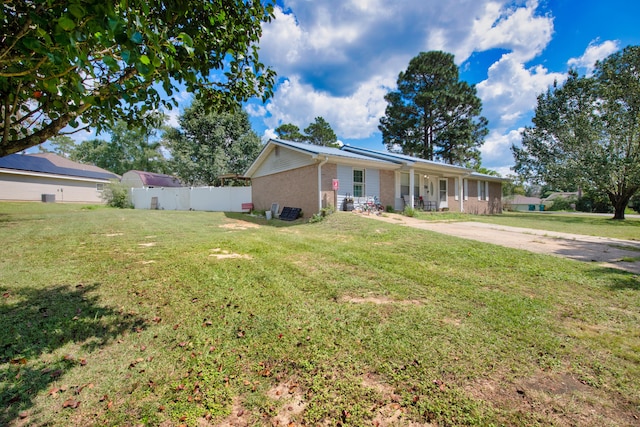 ranch-style house with a front lawn and covered porch