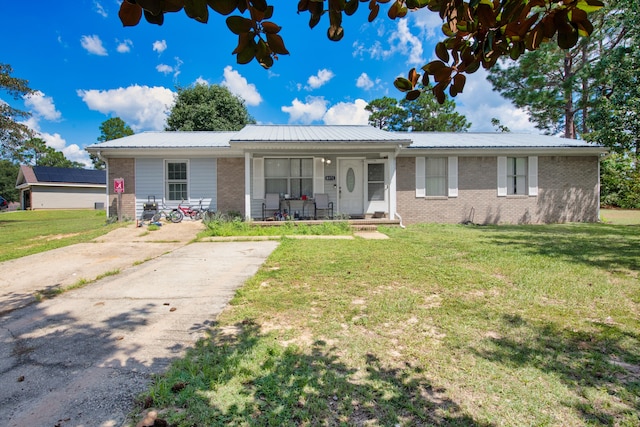 ranch-style house featuring a porch and a front lawn