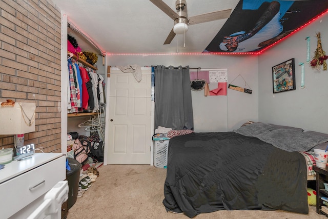 carpeted bedroom featuring ceiling fan and a closet