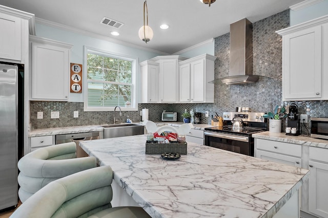 kitchen with sink, wall chimney exhaust hood, stainless steel appliances, and white cabinetry