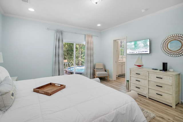 bedroom with light hardwood / wood-style flooring, crown molding, and connected bathroom