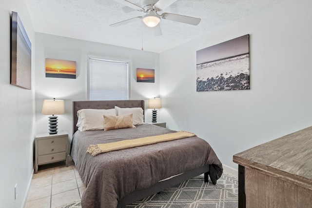 bedroom featuring baseboards, a textured ceiling, a ceiling fan, and tile patterned flooring