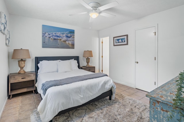 bedroom featuring light tile patterned floors, ceiling fan, and baseboards