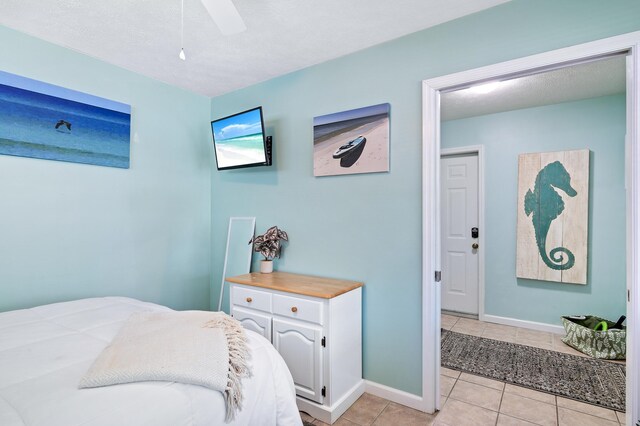 bedroom featuring light tile patterned floors and ceiling fan