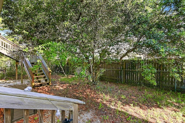 view of yard featuring stairs and fence