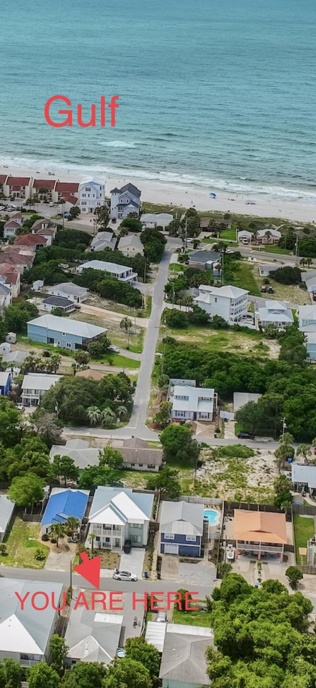 aerial view with a water view and a view of the beach