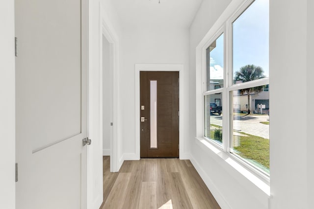 doorway with light wood-type flooring