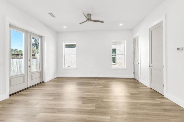 empty room with light hardwood / wood-style floors and ceiling fan