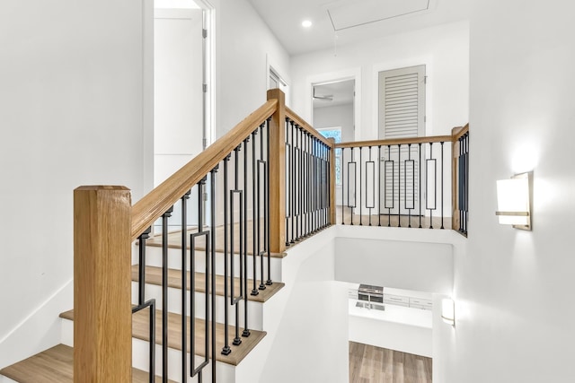 stairs featuring hardwood / wood-style flooring