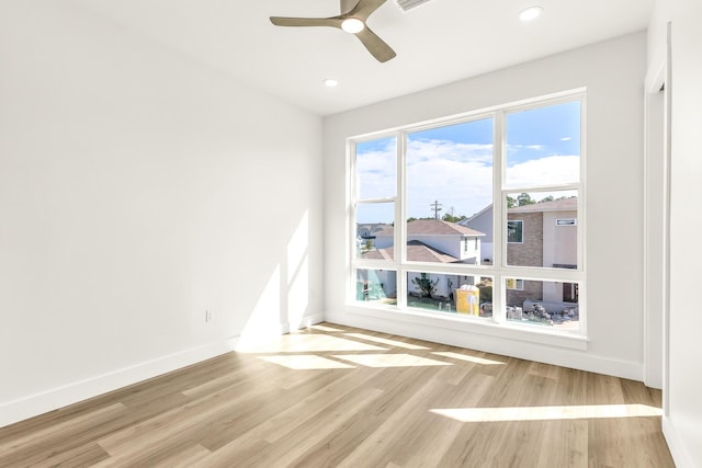 unfurnished room featuring light hardwood / wood-style flooring and ceiling fan