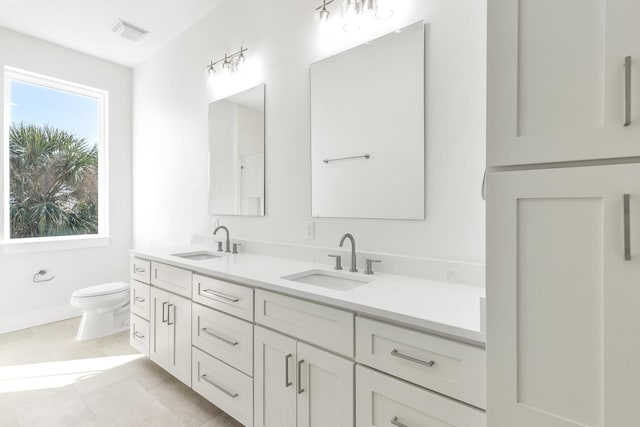 bathroom featuring tile patterned floors, vanity, and toilet