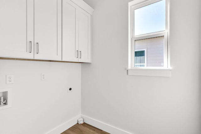 laundry room with cabinets, washer hookup, dark hardwood / wood-style flooring, and electric dryer hookup