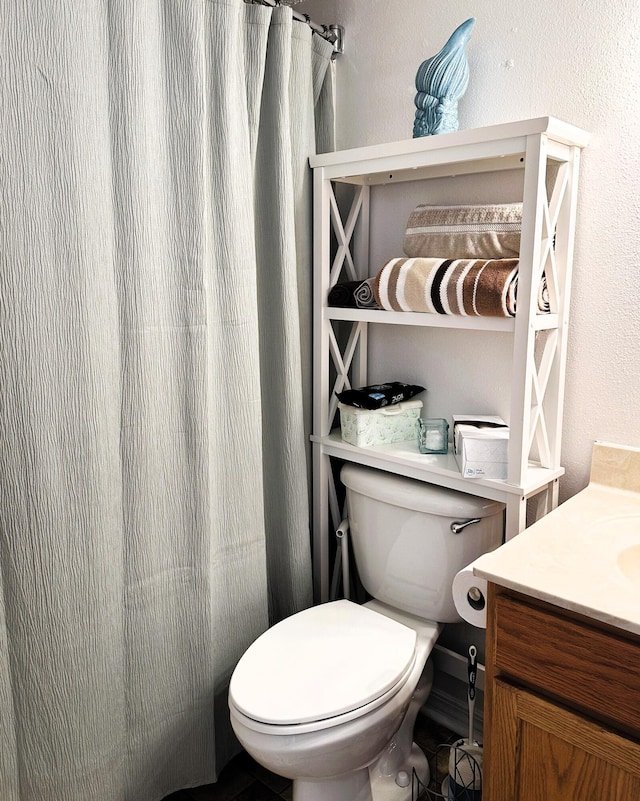 bathroom featuring vanity and toilet