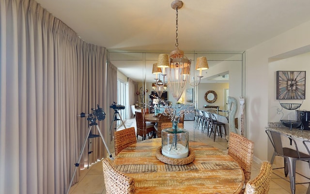 tiled dining room with an inviting chandelier