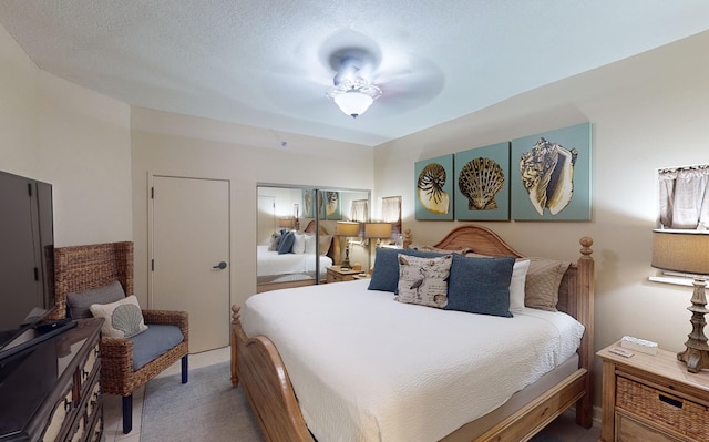 bedroom with a textured ceiling and ceiling fan