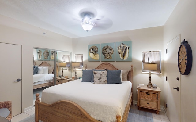 bedroom with ceiling fan and light tile patterned floors