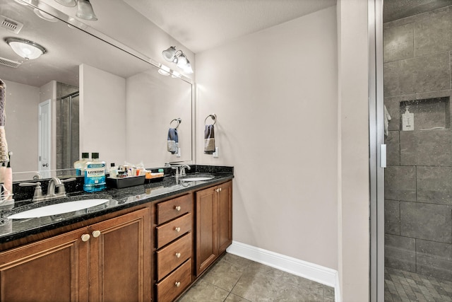 bathroom featuring vanity, tile patterned flooring, and walk in shower