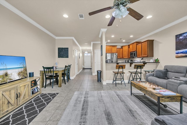 tiled living room featuring crown molding and ceiling fan