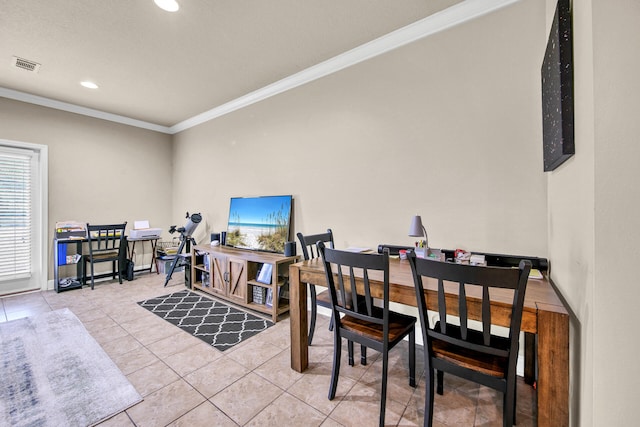 dining area featuring ornamental molding and light tile patterned floors