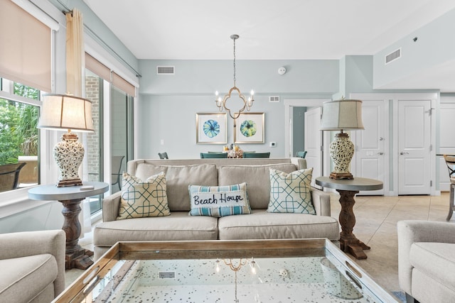 living room with a notable chandelier and light tile patterned floors