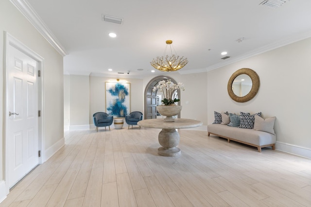 interior space featuring crown molding, light wood-type flooring, and an inviting chandelier