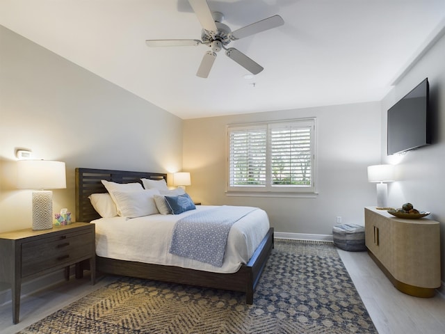 bedroom with ceiling fan and light hardwood / wood-style flooring