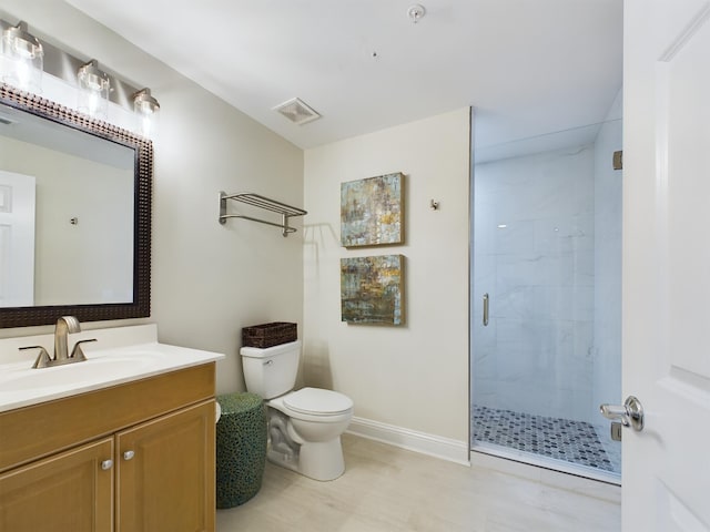 bathroom with toilet, walk in shower, and vanity